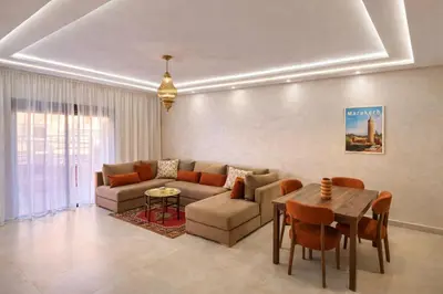a living room with a couch and a table at Appartement spacieux centre ville quartier dynamique in Marrakech