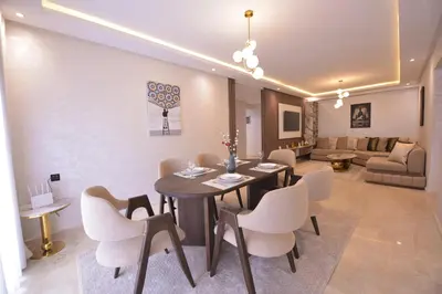 a living room with a dining room table and chairs at Appart Essalam in Marrakech