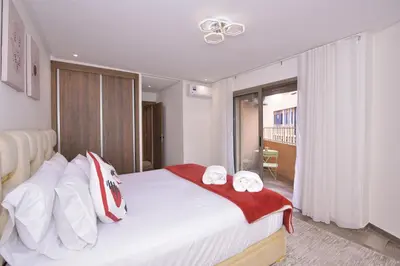 a bedroom with a large white bed with towels on it at Appart Essalam in Marrakech