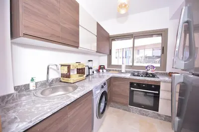 a kitchen with a sink and a dishwasher at Appart Essalam in Marrakech