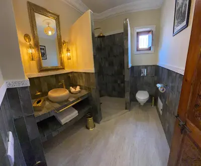 a bathroom with a sink and a toilet at Riad LALA ASMAA Riad privé in Marrakech