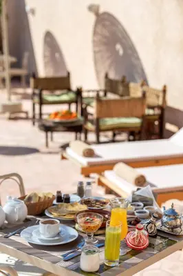 a table with plates of food and drinks on it at Palais Andara Riad And SPA in Marrakech