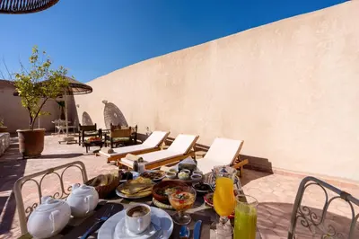 a table with food on it on a patio at Palais Andara Riad And SPA in Marrakech