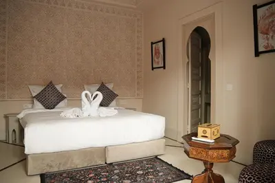 a bedroom with a bed with two swans on it at Palais Andara Riad And SPA in Marrakech
