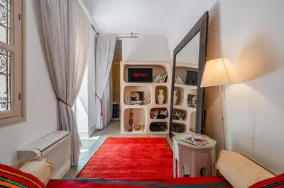 a dressing room with a mirror and a red rug at Riad Litote in the heart of the Kasbah in Marrakech