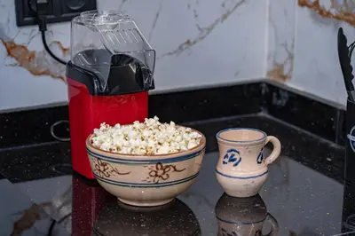 a popcorn dispenser and two bowls of popcorn on a counter at Modern Hivernage Studio Retreat Pool & central access in Marrakech