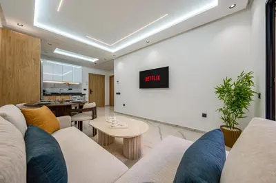 a living room with a couch and a table at Modern Hivernage Studio Retreat Pool & central access in Marrakech