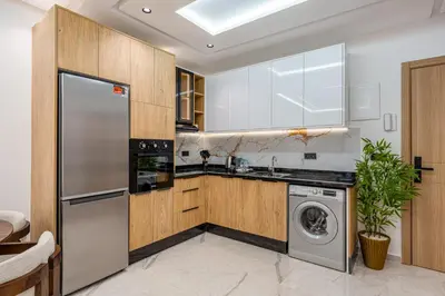 a kitchen with a washer and a dishwasher at Modern Hivernage Studio Retreat Pool & central access in Marrakech