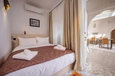 a bedroom with a bed with two towels on it at Riad LILIA in Marrakech