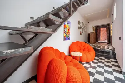 a room with orange chairs and a checkered floor at Riad LILIA in Marrakech