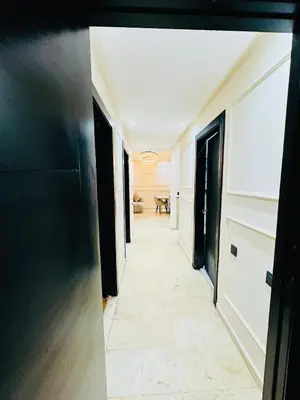 a hallway with black doors and white walls at Chic Stay in Gueliz 2, Parking sur place, Netflix in Marrakech
