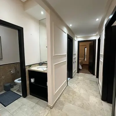 a bathroom with a sink and a toilet and a mirror at Chic Stay in Gueliz 2, Parking sur place, Netflix in Marrakech