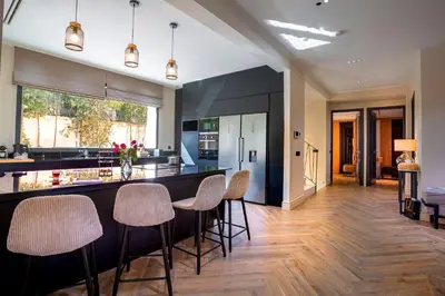 a kitchen with a bar with stools at Villa Syria Marrakech Amelkis 3 in Marrakech