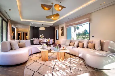 a living room with a large white couch and tables at Villa Syria Marrakech Amelkis 3 in Marrakech