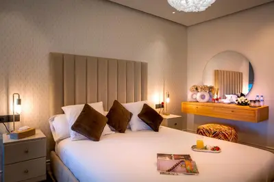 a bedroom with a large white bed and a mirror at Villa Syria Marrakech Amelkis 3 in Marrakech
