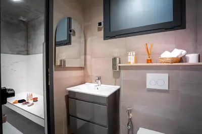 a bathroom with a sink and a toilet and a tv at Villa Syria Marrakech Amelkis 3 in Marrakech