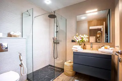 a bathroom with a glass shower and a sink at Villa Syria Marrakech Amelkis 3 in Marrakech