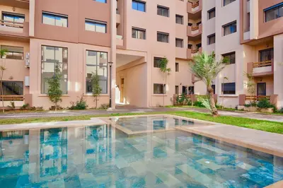 a swimming pool in front of a building at Appartement Gueliz Haut de gamme Residence 5 piscines in Marrakech