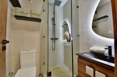 a bathroom with a shower and a toilet and a sink at Appartement Gueliz Haut de gamme Residence 5 piscines in Marrakech
