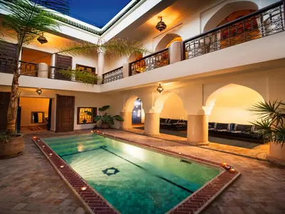 an indoor swimming pool in a house with a building at Riad Darhani in Marrakech