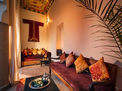 a living room with a couch and a table at Riad Darhani in Marrakech