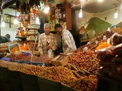 two men standing in a market selling nuts at Riad Darhani in Marrakech
