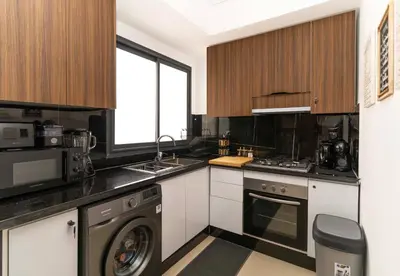 a kitchen with a sink and a dishwasher at Menara Garden Cosy Appartement Hivernage Marrakech in Marrakech