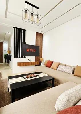 a living room with a couch and a tv at Menara Garden Cosy Appartement Hivernage Marrakech in Marrakech