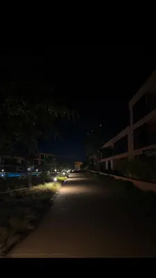 an empty road at night with lights on at Appartement au Domaine de Noria - Terrasse & Piscine in Marrakech