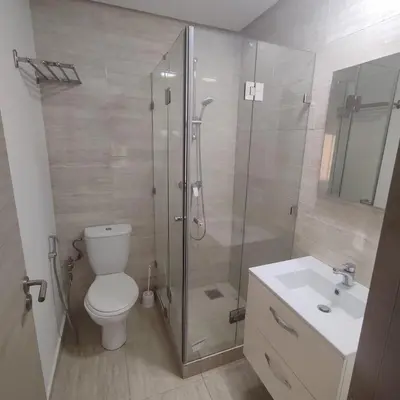 a bathroom with a shower and a toilet and a sink at T3 Jade Prestigia Pool in Marrakech