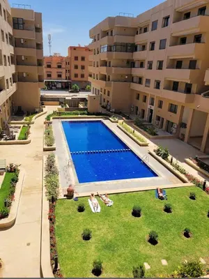 a large swimming pool in the middle of a building at Magnifique appartement avec piscine in Marrakech