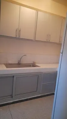 a kitchen with white cabinets and a sink at Bahia in Marrakech