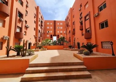 a courtyard of an apartment building with stairs at Stylish apartment with pool access heart of Marrakech gueliz in Marrakech