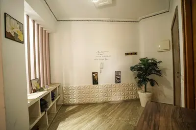 a living room with a potted plant on the wall at Stylish apartment with pool access heart of Marrakech gueliz in Marrakech