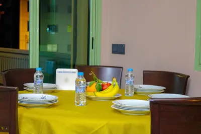 a table with a yellow table cloth and a bowl of fruit at Appartement HIVERNAGE deLUXE en face consulat de france et M avenu CR7 in Marrakech