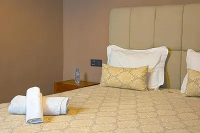 a hotel room with a large bed with pillows at Appartement HIVERNAGE deLUXE en face consulat de france et M avenu CR7 in Marrakech