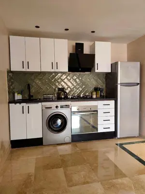 a kitchen with a refrigerator and a washing machine at Calme & moderne - Piscine - Balcon - 2 SDB in Marrakech
