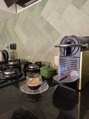a kitchen counter with a bowl of food on a plate at Calme & moderne - Piscine - Balcon - 2 SDB in Marrakech