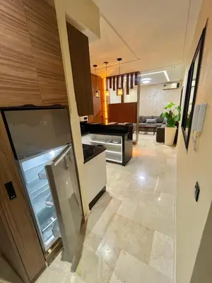 a kitchen with an open refrigerator and a living room at Dar alya in Marrakech
