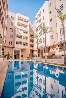 a swimming pool in front of a apartment building at Dar alya in Marrakech