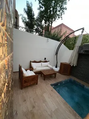 a patio with couches and a table and a pool at Royal Arabian Night in Marrakech