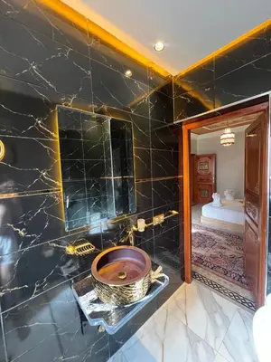 a bathroom with a sink and a large mirror at Royal Arabian Night in Marrakech