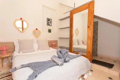 a bedroom with two beds with a teddy bear on them at Guesthouse Better Together in Marrakech