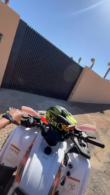 a person holding a helmet on the handle of a motorcycle at Villa Marrakech DAR JAHYR in Douar Ouled Ahmed