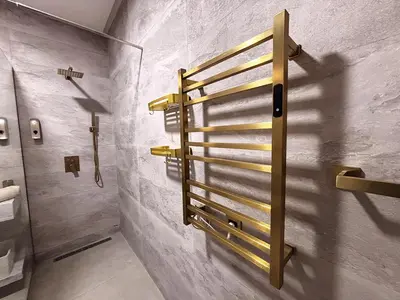 a bathroom with a towel rack on the wall at Villa Marrakech DAR JAHYR in Douar Ouled Ahmed