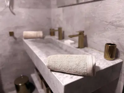 a bathroom with a sink and a towel on a counter at Villa Marrakech DAR JAHYR in Douar Ouled Ahmed