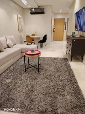 a living room with a couch and a table at appartement-prestigia-saphir-marrakech in Marrakech