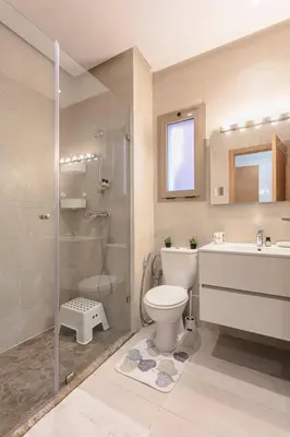 a bathroom with a toilet and a shower and a sink at appartement-prestigia-saphir-marrakech in Marrakech