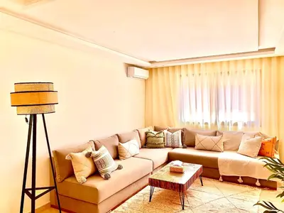 a living room with a couch and a table at Studio bien équipé au centre de gueliz gueliz in Marrakech