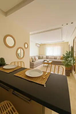 a living room with a table and a couch at Studio bien équipé au centre de gueliz gueliz in Marrakech